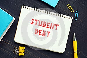 STUDENT DEBT sign on the sheet. Student debtÂ refers to loans used to pay for college tuition that are due after the student